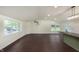 Spacious open-concept living area with hardwood floors, brick accents and plentiful natural light at 125 S Alfonte St, Ingalls, IN 46048