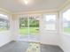 Bright sunroom with sliding glass door access to the back yard and beautiful wainscoting at 125 S Alfonte St, Ingalls, IN 46048