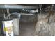 Unfinished basement with concrete walls, water heater and pipes at 127 S Belmont Ave, Indianapolis, IN 46222