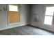 Empty bedroom with boarded window and graffiti on the walls at 127 S Belmont Ave, Indianapolis, IN 46222