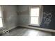 This bedroom has graffiti on walls and new flooring at 127 S Belmont Ave, Indianapolis, IN 46222