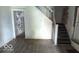 The entryway has stairs, visible wall damage and graffiti at 127 S Belmont Ave, Indianapolis, IN 46222