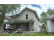 Two-story home with a covered front porch and a yard at 127 S Belmont Ave, Indianapolis, IN 46222