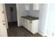 A kitchen with a simple sink and white cabinets at 127 S Belmont Ave, Indianapolis, IN 46222