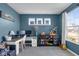 Well-lit bedroom features a desk, decor display, and a sunny window view of the neighborhood at 1381 Avocet Dr, Greenwood, IN 46143