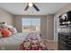 This bedroom boasts a window, bed, and dresser, offering a relaxing haven to recharge at 1381 Avocet Dr, Greenwood, IN 46143