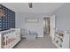 Bright Bedroom with whimsical decor, crib, and easy access to closet and hallway at 1381 Avocet Dr, Greenwood, IN 46143