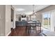 Bright dining area featuring a modern light fixture, table with four chairs, and sliding glass doors to the yard at 1381 Avocet Dr, Greenwood, IN 46143