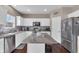 Modern kitchen featuring white cabinets, stainless steel appliances, gray countertops, and a stylish center island at 1381 Avocet Dr, Greenwood, IN 46143