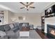 Inviting living room features a comfortable gray sectional sofa, fireplace, and view of the outdoors at 1381 Avocet Dr, Greenwood, IN 46143