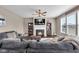 Cozy living room features a fireplace, ceiling fan, plush gray sofa, and TV for relaxed entertainment at 1381 Avocet Dr, Greenwood, IN 46143