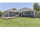 This home's backyard features a wooden deck, green lawn, and mature landscaping at 1480 E Jefferson St, Franklin, IN 46131