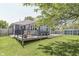 The house features a backyard deck, a lawn, and mature trees for shade at 1480 E Jefferson St, Franklin, IN 46131