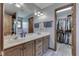 Dual sink bathroom with spacious vanity, mirror and a walk in closet on the side at 1480 E Jefferson St, Franklin, IN 46131
