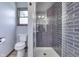 Tiled shower stall, sleek toilet, and gray accent color at 1480 E Jefferson St, Franklin, IN 46131