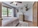 Traditional-style bedroom with a large window, wood dresser, and unique decorative accents at 1480 E Jefferson St, Franklin, IN 46131