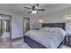 Comfortable bedroom with wood accent wall and large bed with side table and hanging lights at 1480 E Jefferson St, Franklin, IN 46131