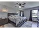 Inviting bedroom with wood-look accent wall, neutral bedding, and ambient pendant lighting at 1480 E Jefferson St, Franklin, IN 46131