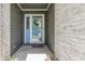 Close-up of the home's front door showcasing its stylish design, sidelight and brick surround at 1480 E Jefferson St, Franklin, IN 46131