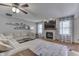 Cozy living room with a fireplace, comfortable sectional sofa, large windows, and stylish decor at 1480 E Jefferson St, Franklin, IN 46131