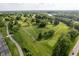 Aerial shot of golf course, surrounded by mature trees and features a water hazard at 1502 Burdsal Pkwy, Indianapolis, IN 46208