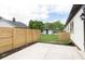 Inviting backyard with a concrete patio, wooden fence, and manicured lawn, perfect for outdoor gatherings at 1502 Burdsal Pkwy, Indianapolis, IN 46208