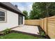 Charming backyard with a concrete patio, wooden fence, and lush landscaping, ideal for outdoor enjoyment at 1502 Burdsal Pkwy, Indianapolis, IN 46208