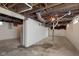 Unfinished basement with exposed ductwork and block foundation walls, providing a blank canvas for remodeling at 1502 Burdsal Pkwy, Indianapolis, IN 46208