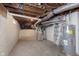 Unfinished basement with exposed ductwork, a furnace, and a water heater, offering potential for customization at 1502 Burdsal Pkwy, Indianapolis, IN 46208