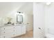 Bright bathroom featuring a vanity with marble countertops, cabinets, and a toilet on the side at 1502 Burdsal Pkwy, Indianapolis, IN 46208