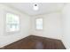 Bedroom with two windows, hardwood floors and white walls at 1502 Burdsal Pkwy, Indianapolis, IN 46208