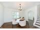 Bright dining room features hardwood floors and a modern chandelier, creating an elegant dining experience at 1502 Burdsal Pkwy, Indianapolis, IN 46208