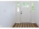 Bright entryway featuring a white front door with sidelights, enhancing natural light and curb appeal at 1502 Burdsal Pkwy, Indianapolis, IN 46208