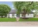 Charming home with lush lawn and mature trees, creating a serene and inviting outdoor space at 1502 Burdsal Pkwy, Indianapolis, IN 46208