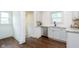 Modern kitchen with white cabinets, stainless steel appliances, and hardwood floors at 1502 Burdsal Pkwy, Indianapolis, IN 46208