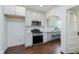Modern kitchen with white cabinets, stainless steel appliances, and hardwood floors at 1502 Burdsal Pkwy, Indianapolis, IN 46208