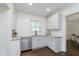 Bright kitchen features white cabinets, stainless steel appliances, and granite countertops at 1502 Burdsal Pkwy, Indianapolis, IN 46208