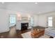 Bright living room featuring a fireplace, dark hardwood floors, and neutral decor at 1502 Burdsal Pkwy, Indianapolis, IN 46208