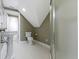 Cozy bathroom with a shower and pedestal sink with white tile floors at 1526 Carrollton Ave, Indianapolis, IN 46202