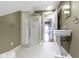 Attic bathroom with a pedestal sink, stand up shower, and a view to the hallway at 1526 Carrollton Ave, Indianapolis, IN 46202