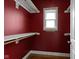 Bright closet featuring wood floors, white shelves, and a window for natural light at 1526 Carrollton Ave, Indianapolis, IN 46202