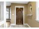 Inviting entryway showcasing a dark wood door, tiled floors, and neutral walls with decorative accents at 1526 Carrollton Ave, Indianapolis, IN 46202