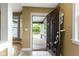 Inviting entryway view showing front door, hardwood floors, neutral walls, and plenty of natural light at 1526 Carrollton Ave, Indianapolis, IN 46202