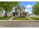 Beautiful two-story duplex with a well-manicured lawn and mature trees, showcasing its classic architectural design at 1526 Carrollton Ave, Indianapolis, IN 46202