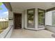 Inviting front porch with classic architectural details and ample natural light, featuring a dark wood front door at 1526 Carrollton Ave, Indianapolis, IN 46202