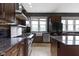Stylish kitchen featuring stainless steel appliances, granite countertops, and a farmhouse sink at 1526 Carrollton Ave, Indianapolis, IN 46202