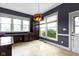 Spacious kitchen featuring large windows, custom cabinetry, desk area, and unique light fixture at 1526 Carrollton Ave, Indianapolis, IN 46202