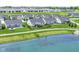 A stunning aerial view showcasing the homes surrounding a serene lake and a paved walking path at 1530 Gristmill Meadows Dr, Westfield, IN 46074