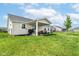 Expansive backyard with a covered patio, lush lawn, and black fence providing privacy and curb appeal at 1530 Gristmill Meadows Dr, Westfield, IN 46074