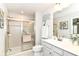 Bright bathroom featuring a tiled shower with glass door, neutral paint, and a lovely vanity at 1530 Gristmill Meadows Dr, Westfield, IN 46074